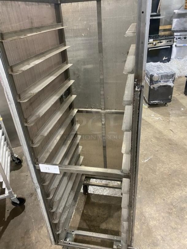 Commercial aluminum full-height bun/sheet pan rack with corrugated sidewalls, on casters. Used condition, tag labeled "73".