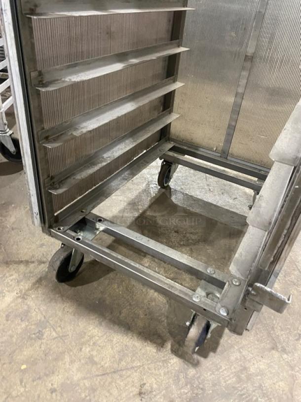 Commercial aluminum full-height bun/sheet pan rack with corrugated sidewalls on casters, used condition.