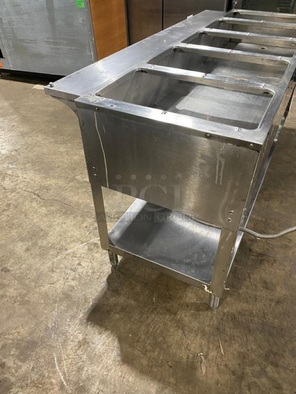 Duke Aerohot Series gas-powered, stainless steel 5-well hot food table. Includes single undershelf and stands on legs.