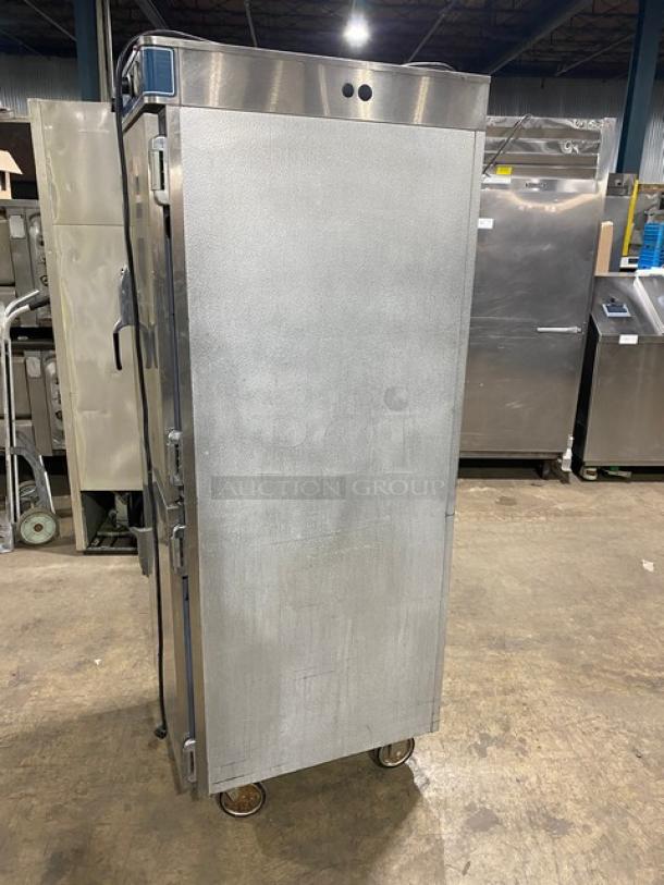 Alto-Shaam Halo Heat stainless steel dual-compartment heated cabinet with solid Dutch doors, individual controls, and universal rack on casters.