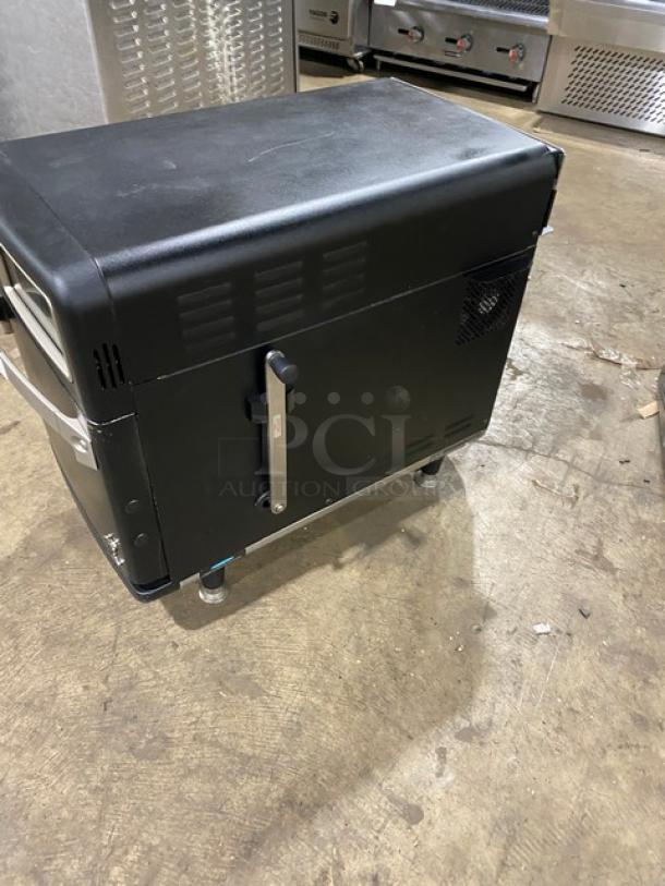 TurboChef NGO commercial countertop oven, black, electric 208/240V, ventless rapid cook, with crank bar, on legs.