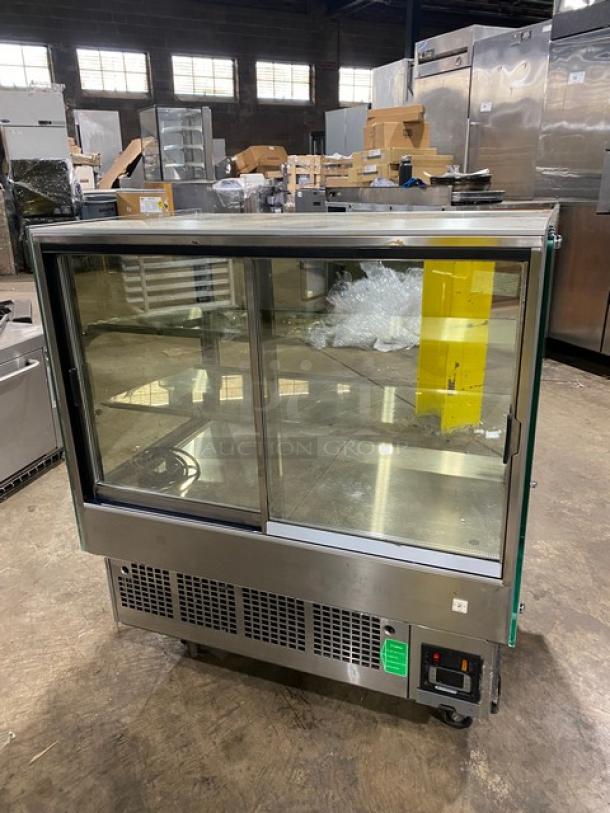 Kinco stainless steel refrigerated display case, model CNZ-90CM, straight-glass, multi-tier, with rear sliding doors, on casters.