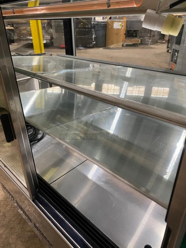 Kinco CNZ90CM stainless steel bakery display case, straight-glass with multi-tier shelves, rear sliding doors, on casters.