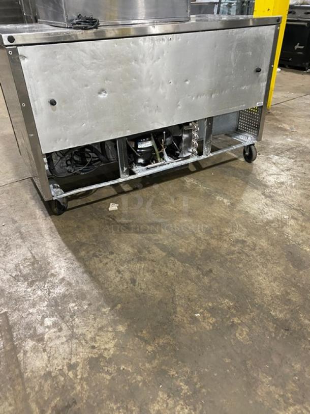 True TUC-60 stainless steel 2-door worktop refrigerator, 60" wide, on casters, back panel open, commercial use.