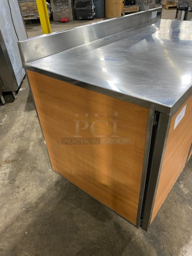 Duke Commercial Stainless Steel 2 Door Refrigerator, Model RBC60M, with up-turned backsplash, on legs; working condition.