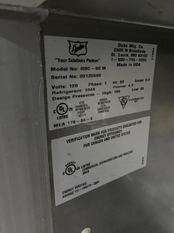 Duke Commercial Stainless Steel 2 Door 60" Worktop Refrigerator, Model RBC-60M, SN: 09135680, 120V, 1 Phase, with up-turned backsplash, on legs, working condition.