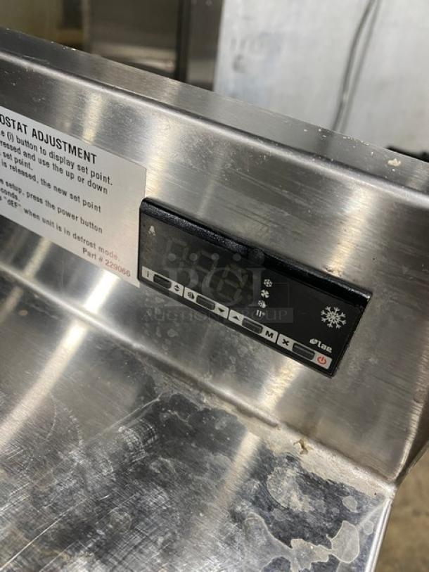 Duke RBC-60M stainless steel 60" worktop refrigerator with upturned backsplash, digital thermostat, on legs, model plate visible.