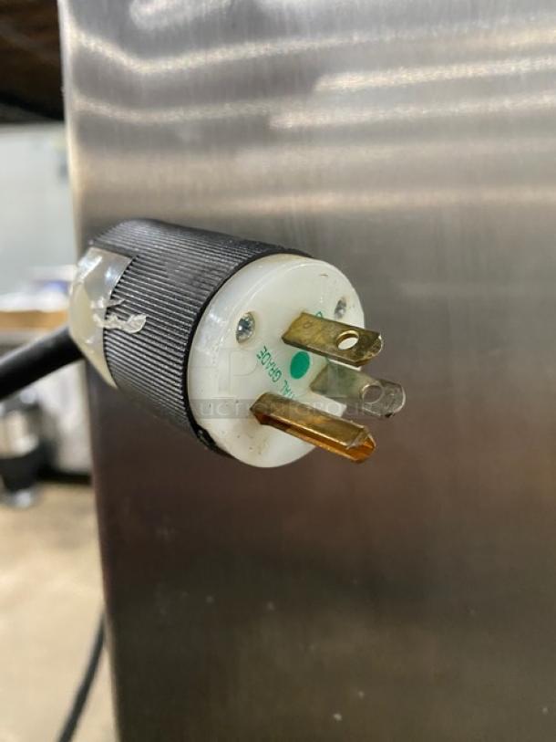 Traulsen AHT232NUT stainless steel reach-in refrigerator; 4 doors, with built-in pan slides; 115V, on legs, good condition.