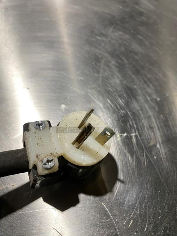 Electric plug of Piper Products RCM051S blast chiller. Slight wear visible on metal prongs and plastic casing.