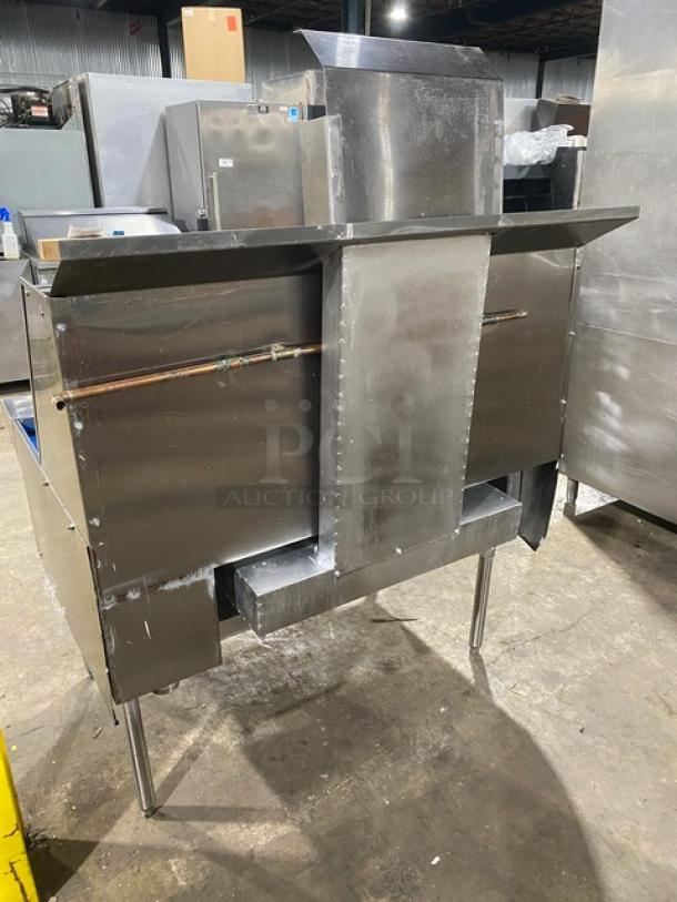 Commercial stainless steel 2-burner gas wok range with backsplash, dual swivel spout faucet, on legs.