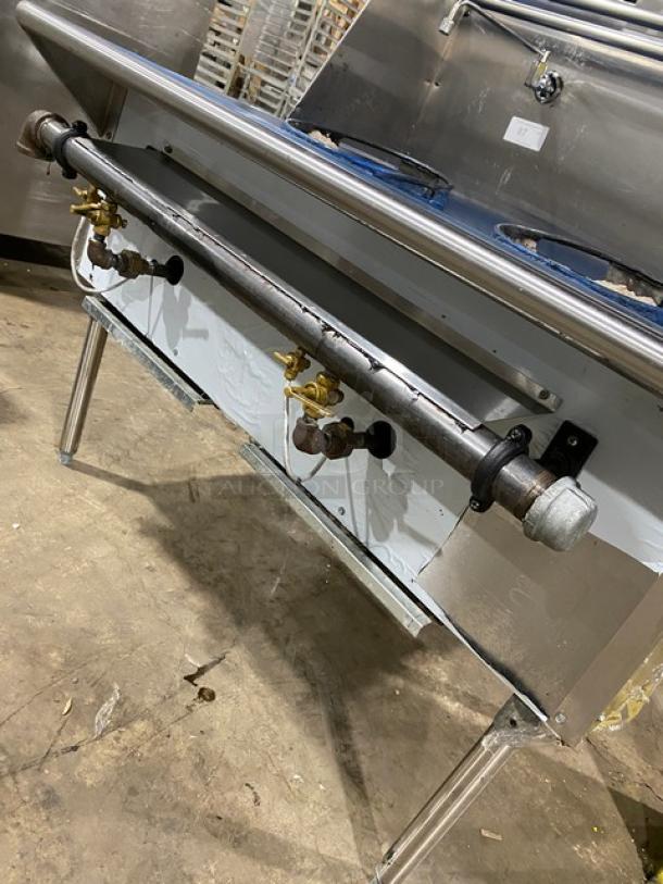 Commercial stainless steel 2-burner gas wok range with backsplash and dual swivel spout faucet, on sturdy legs.