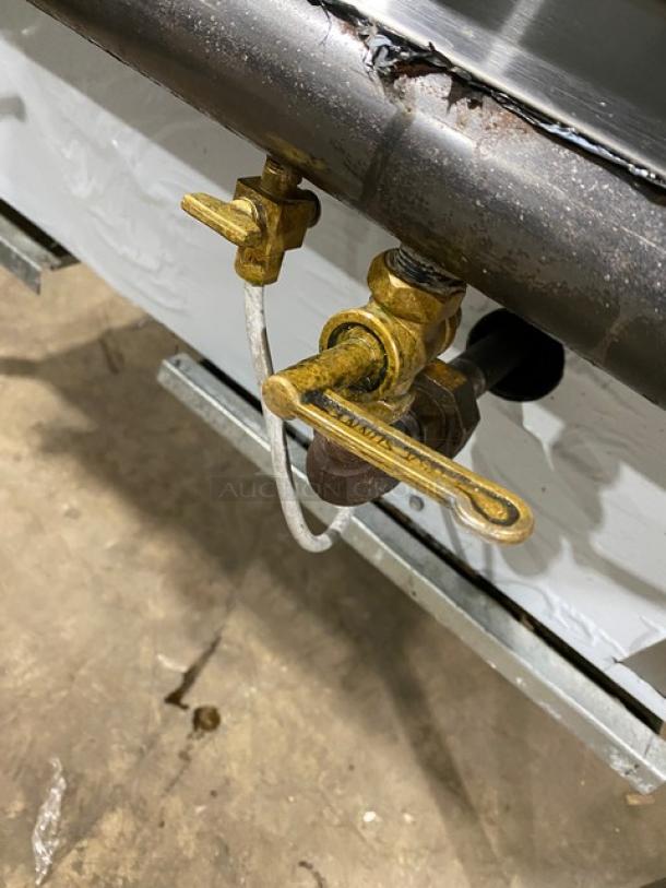 Commercial stainless steel gas-powered 2-burner Chinese wok range with backsplash, dual swivel spout faucet; on legs.