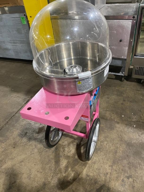Olde Midway Spin-2000 hot-pink cotton candy machine/cart with 20" stainless bowl, clear dome lid, wheels, and 110V power.