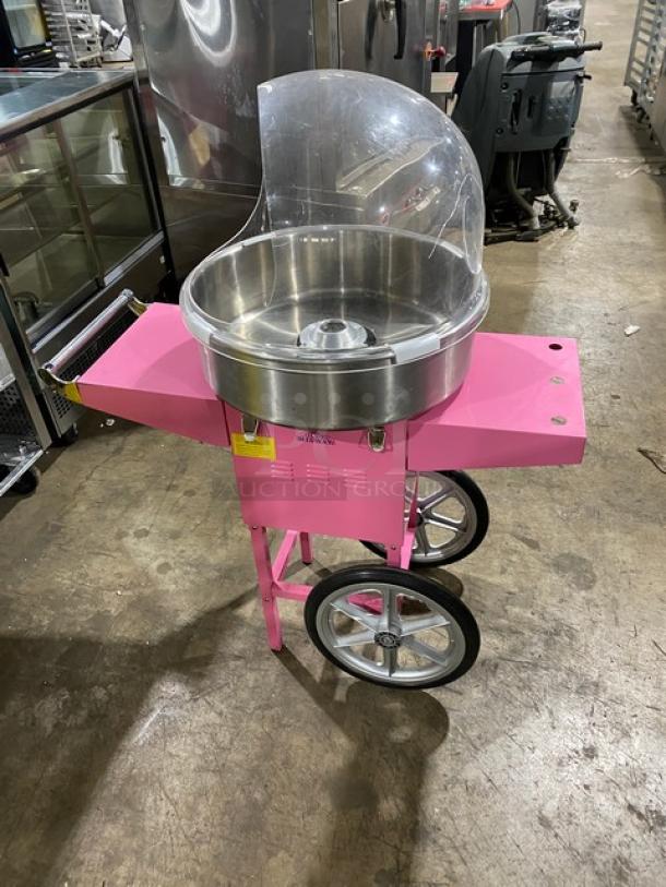 Olde Midway Spin-2000 Series pink cotton candy machine with stainless steel bowl and bubble shield, on wheeled cart.