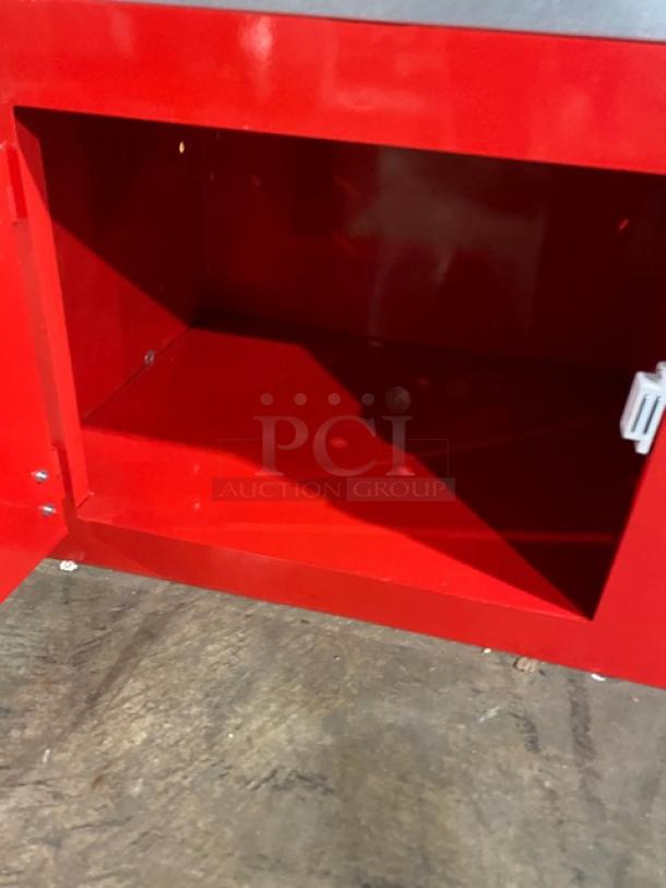 Carnival King red stainless steel popcorn machine's inner cabinet-style storage, showcasing spacious compartment.