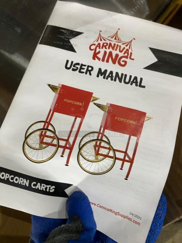 Carnival King Commercial Popcorn Machine user manual, showing red popcorn carts with wheels. Dated 04/2021.