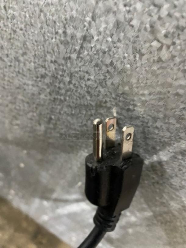 Close-up of an electric plug for the Marchia MDC161 refrigerated display case; standard three-prong plug for 110-120V.