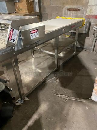 Rondo floor-style belt conveyor system, stainless steel, with visible safety warnings and power cables, in used condition.