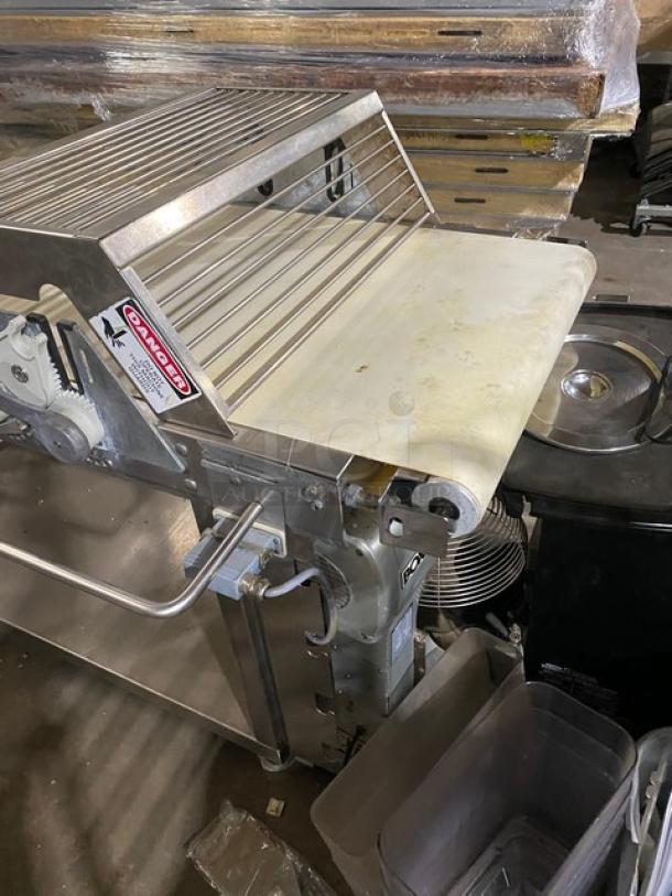 Rondo Floor Style Belt Conveyor System; stainless steel, used condition, with visible safety warning label.