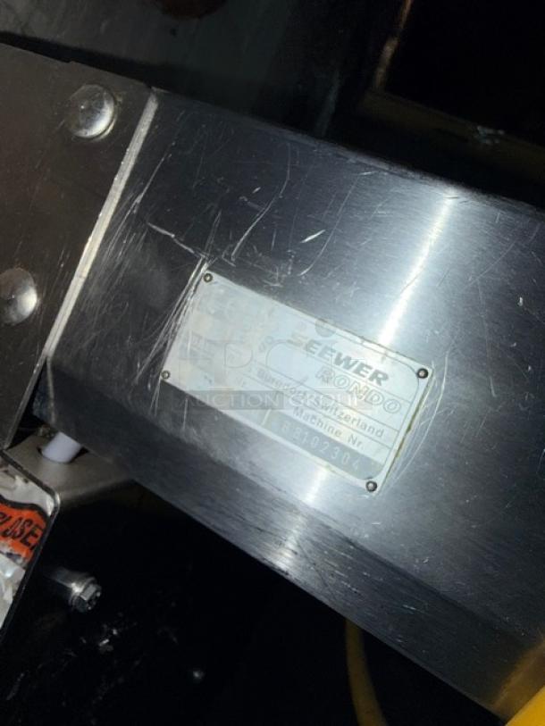 Seewer Rondo Conveyor System, Model SBEVERR, Serial B8102304, stainless steel with label, on casters, good condition.