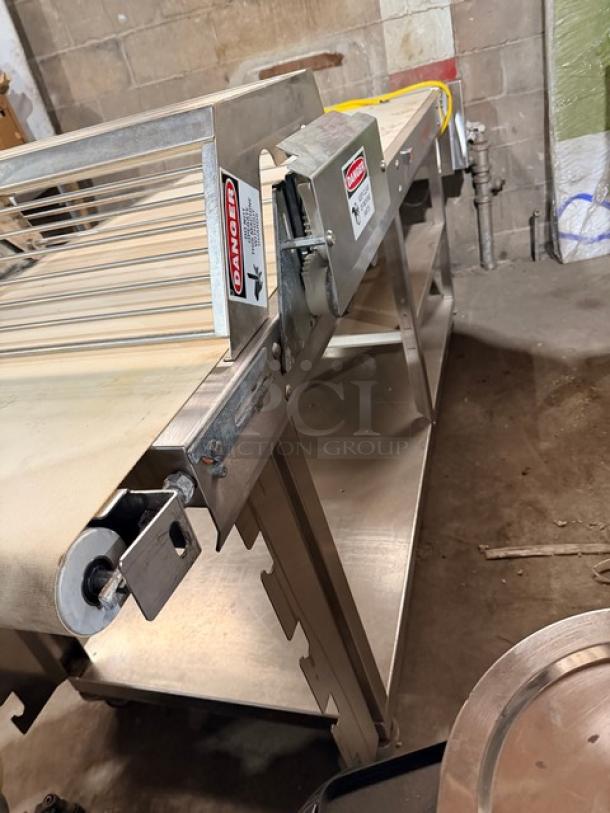 Rondo Seewer Model SBEVERR belt conveyor system on casters, serial B8102304, features metal frame, visible danger labels.