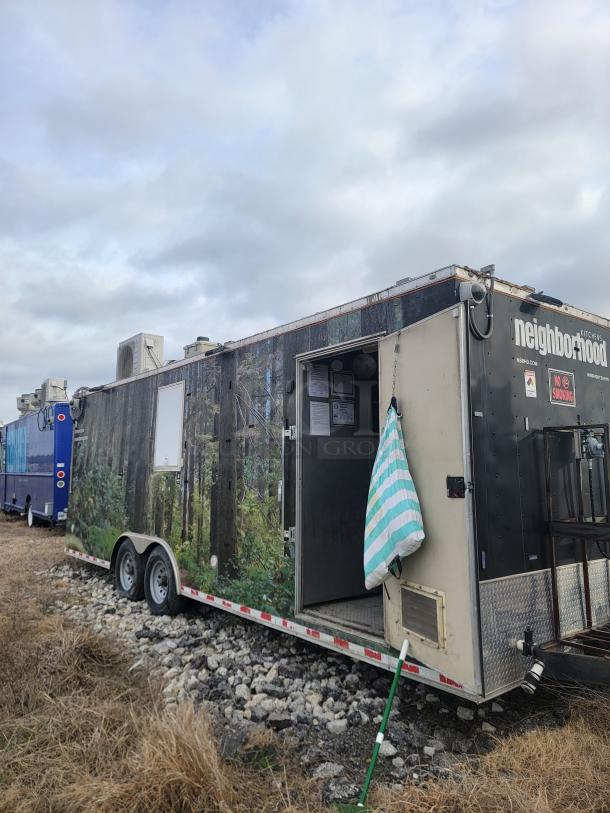 2021 Diamond Cargo 24' mobile kitchen trailer with forest wrap, 14,000 lbs GVWR. Features open door and exterior signage.