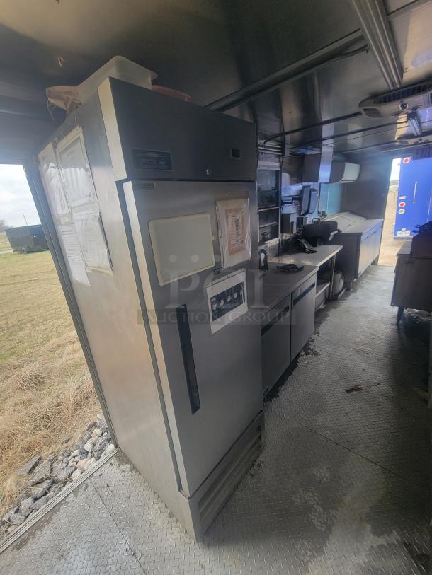 Diamond Cargo 24' mobile kitchen trailer interior, 2021 model, stainless steel appliances, robust equipment setup, clean condition.