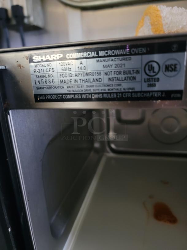 Sharp commercial microwave oven plaque, model R-21LCFS, 120VAC, made May 2021 in Thailand. UL and NSF listed.
