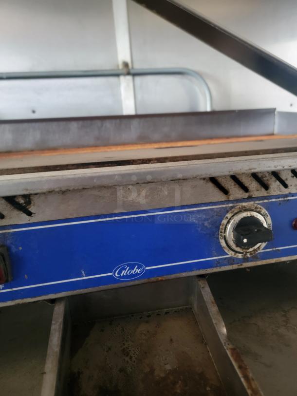 Griddle inside a Diamond Cargo 24' mobile kitchen trailer, featuring a Globe control panel. Used, with visible wear.