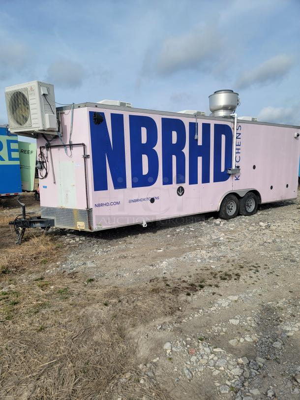 Haulmark 24' mobile kitchen trailer in pink, NBRHD Kitchens branding, equipped with refrigeration, fire suppression, climate control.