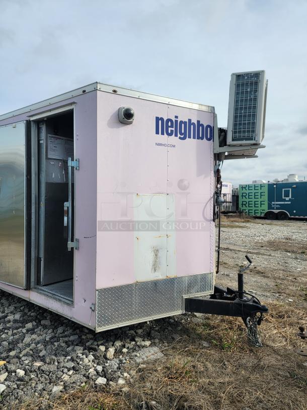 Haulmark 24' mobile kitchen trailer, pink exterior, with air conditioning unit and surveillance camera, NBRHD Kitchens branding.