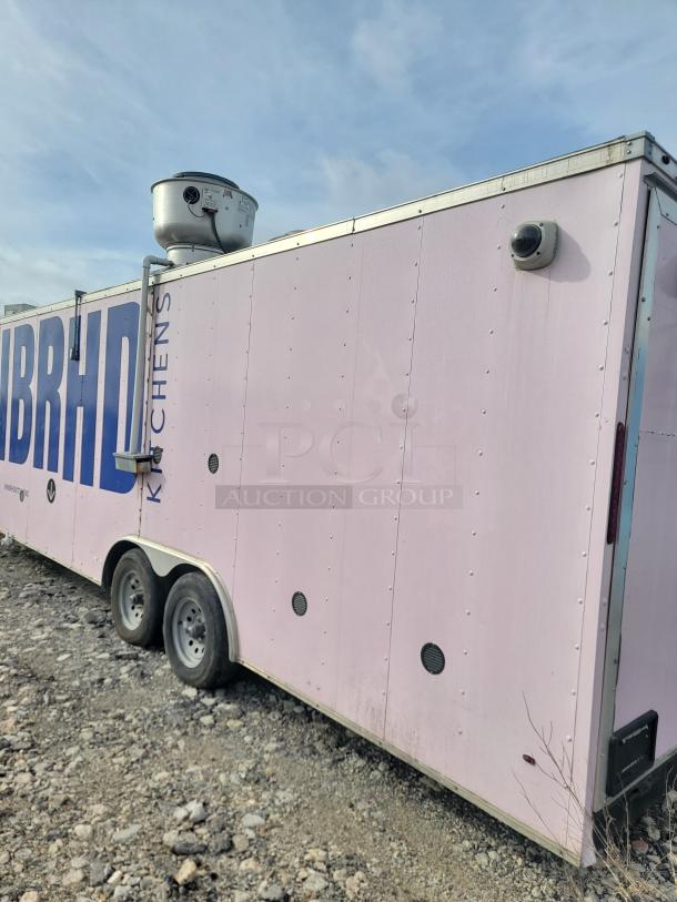 24' Haulmark mobile kitchen trailer, pink exterior, NBRHD Kitchens branding, equipped with commercial refrigeration.