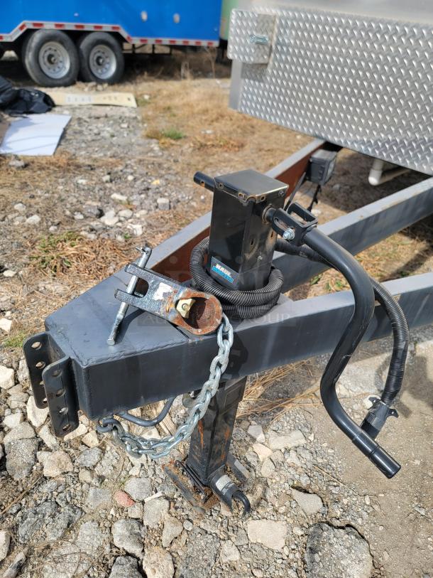 Trail hitch and chain of 2021 Texino FD-306 mobile kitchen trailer, showing rust and need for maintenance.