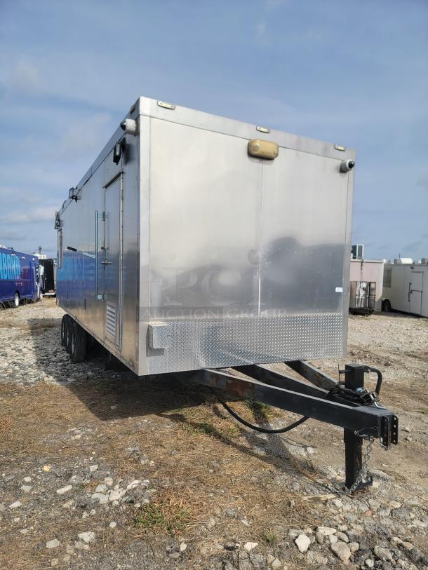 28' Texino FD-306 mobile kitchen trailer with triple-axle frame, stainless steel exterior. Needs TLC and deep cleaning.