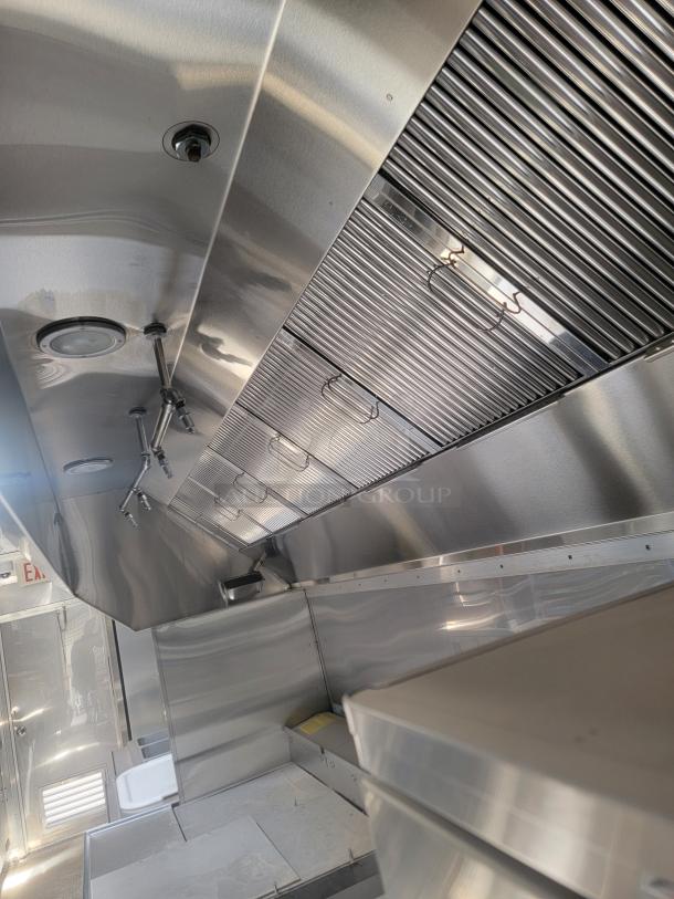 2021 Texino FD-306 mobile kitchen interior, stainless steel, triple-axle, premium commercial equipment, requires cleaning.