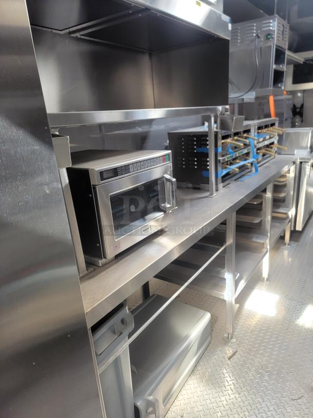 2021 Texino FD-306 mobile kitchen interior with stainless steel shelving, Blodgett convection oven, and other commercial equipment.