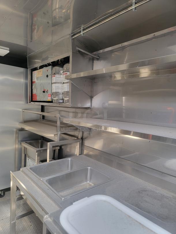 2021 Texino FD-306 mobile kitchen interior, stainless steel, triple-axle, with commercial-grade equipment, needs cleaning.
