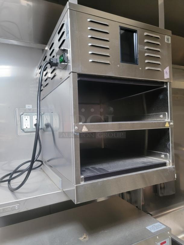 Stainless steel commercial oven in a Texino FD-306 mobile kitchen, featuring ventilation and power cords, needs cleaning.