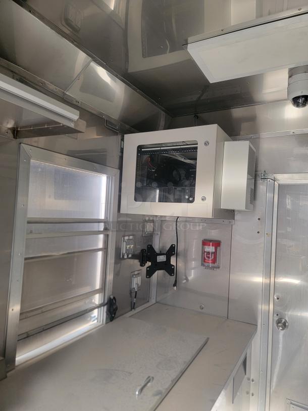 2021 Texino FD-306 mobile kitchen interior, showing stainless steel walls, a mounted electrical panel, and storage area. Needs cleaning.