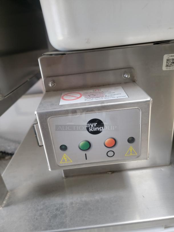 AyrKing control panel on stainless steel equipment with caution symbols and power buttons in a 2021 Texino FD-306 mobile kitchen.