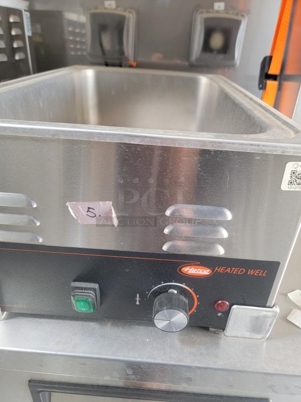 Hatco Heated Well in Texino FD-306 kitchen, stainless steel, temperature control knob, sticker label with "5," needs cleaning.