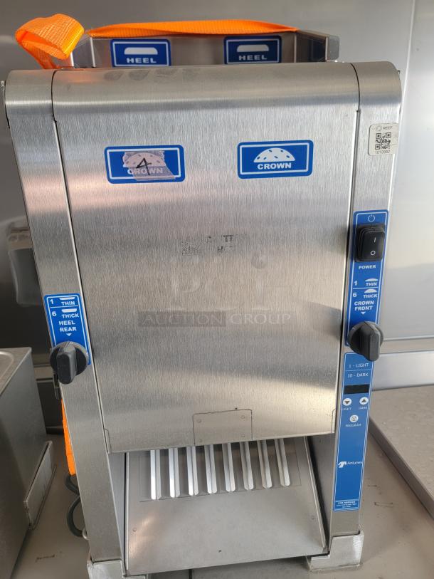 Crown commercial kitchen appliance with stainless steel finish, control knobs for thickness and toasting, and visible branding.