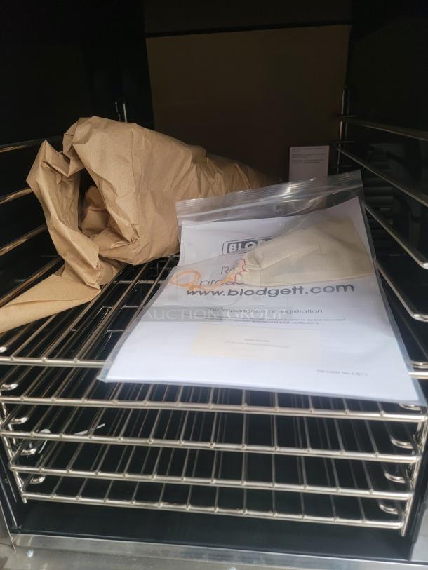 Blodgett convection oven inside a 28' Texino FD-306 mobile kitchen with racks, paperwork, and packaging materials. Needs cleaning.
