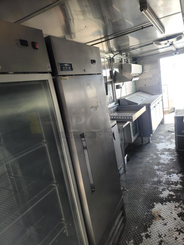 2020 Diamond Cargo mobile kitchen interior with Arctic Air fridge, Wells griddle and range, and True prep station; used condition.