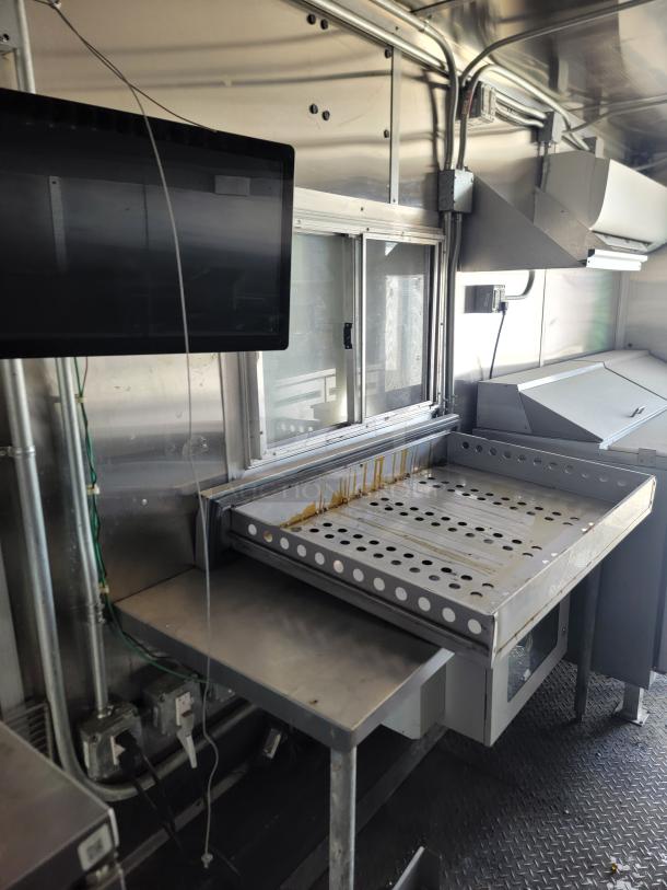 2020 Diamond Cargo Mobile Kitchen interior with prep station, griddle, stainless steel finish, and mounted monitor.