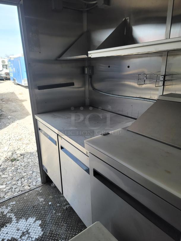 Mobile kitchen interior with stainless steel counters and storage. Features high-volume prep space on Diamond Cargo 2020 model.