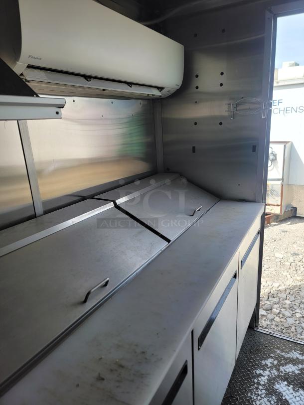 2020 Diamond Cargo 24' mobile kitchen interior; stainless prep station, overhead commercial air unit.
