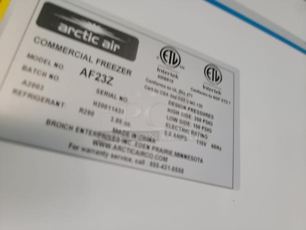 Label on Arctic Air commercial freezer model AF23Z, detailing serial number, design pressures, and electrical specifications.