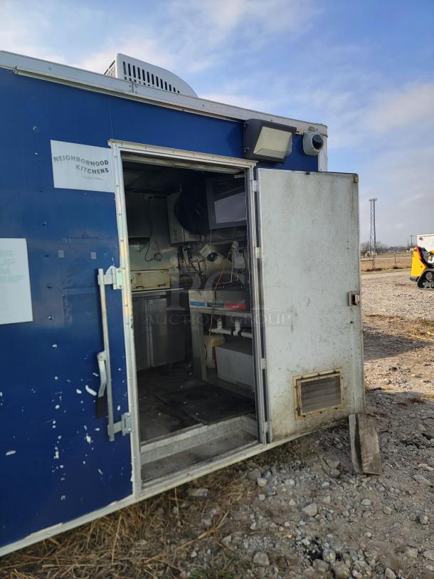 2019 Quality Cargo 24' mobile ghost kitchen, open door showing interior. Needs deep clean and body TLC. Includes Garland range.