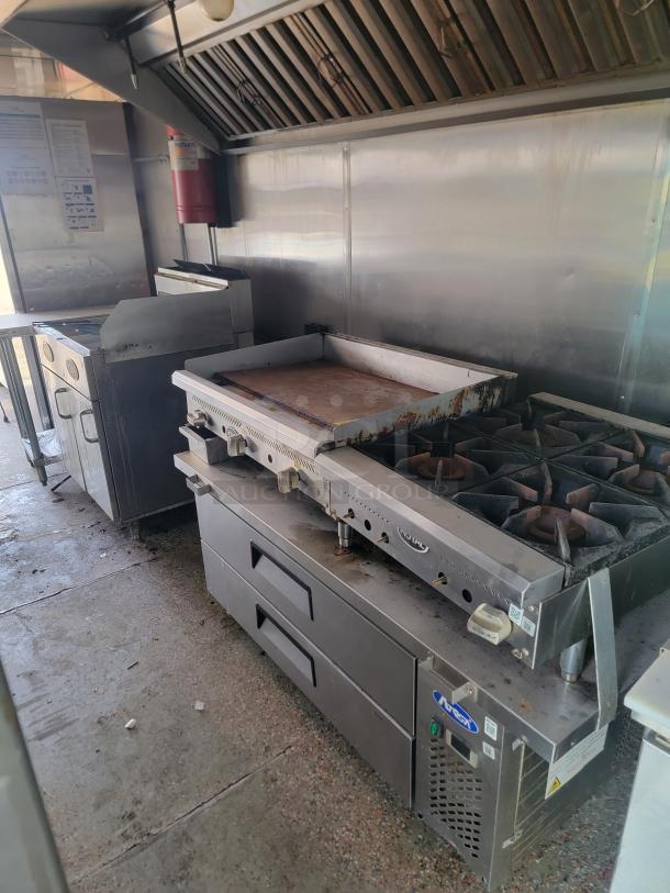 2019 Quality Cargo 24' mobile kitchen featuring Garland 4-burner range, interior needs scrubbing, exterior needs TLC.
